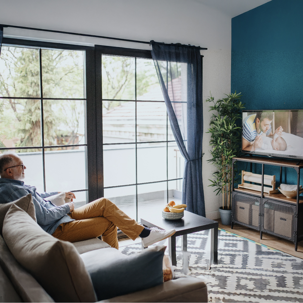 A room with a running TV